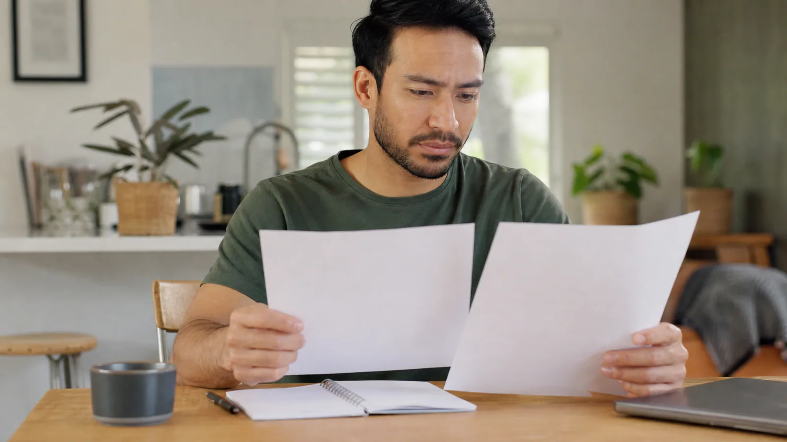 Illustrative editorial scene of a worker comparing an earlier claim acceptance with a later liability decision.