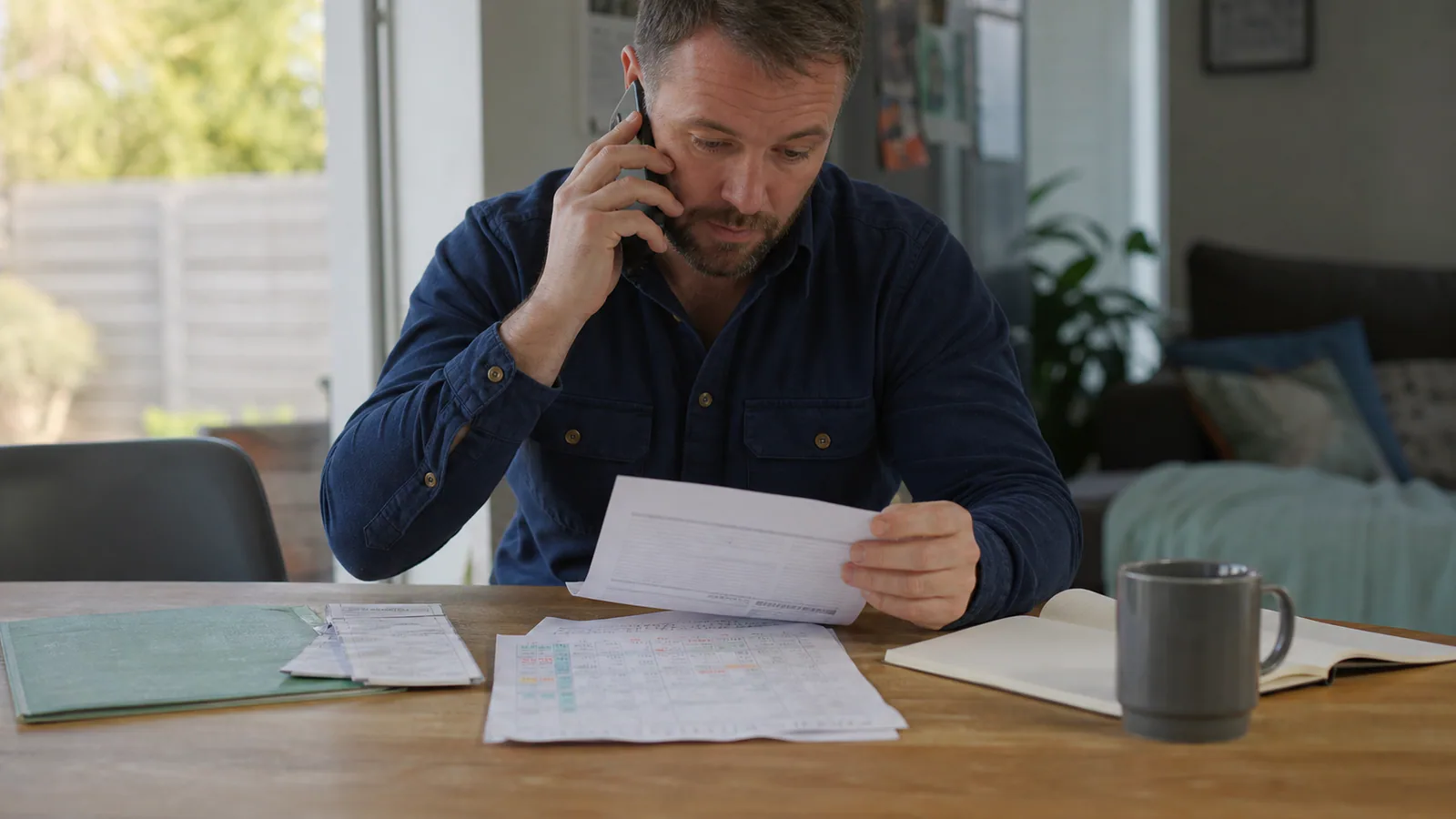 Illustrative editorial scene of a worker comparing sick leave, annual leave, capacity and payment records by phone.